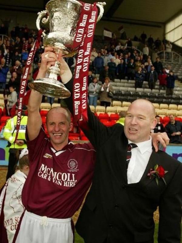 Jim Sinnet holding the Junior Cup aloft
